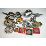A small collection of automobile / car club grill badges together with a small group of