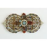 An ornate brass two piece belt buckle with enamel decoration.