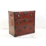 Oriental Red Stained Campaign style Chest of Three Drawers with metal mounts and carrying handles,