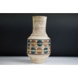 Troika Urn Shaped Vase decorated with a double banding of blue and brown circles, on a rough