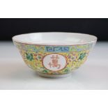 Chinese yellow ground circular bowl with scrolling Famille Rose floral decoration, four character