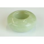 Chinese Jade Brush Washer of compressed circular form on a slightly raised base, 6.5cm diameter x