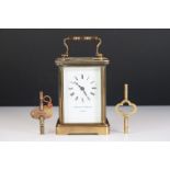 A brass cased carriage clock with bevelled glass panels, Matthew Norman of London, complete with