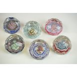 Six Whitefriars faceted glass concentric millefiori paperweights, of varying colours, to include
