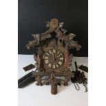 A German Black Forest traditional cuckoo clock complete with weights.