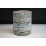 Troika pottery cylindrical lamp base decorated with a striped band of circles on a textured grey