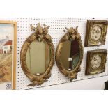 Pair of 19th century Plaster Gilt Wall Mirrors, the oval plates within bead frames surmounted by