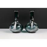 Pair of Mary Gregory style blue glass bottle-shaped vases, with white enamel decoration of