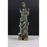 Chinese carved jadeite figure of Guanyin, the figure in flowing robes holding a flower, 26cm high