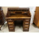 Early 20th century Oak Roll Top Desk, the tambour front rolling back to a fitted interior, over an