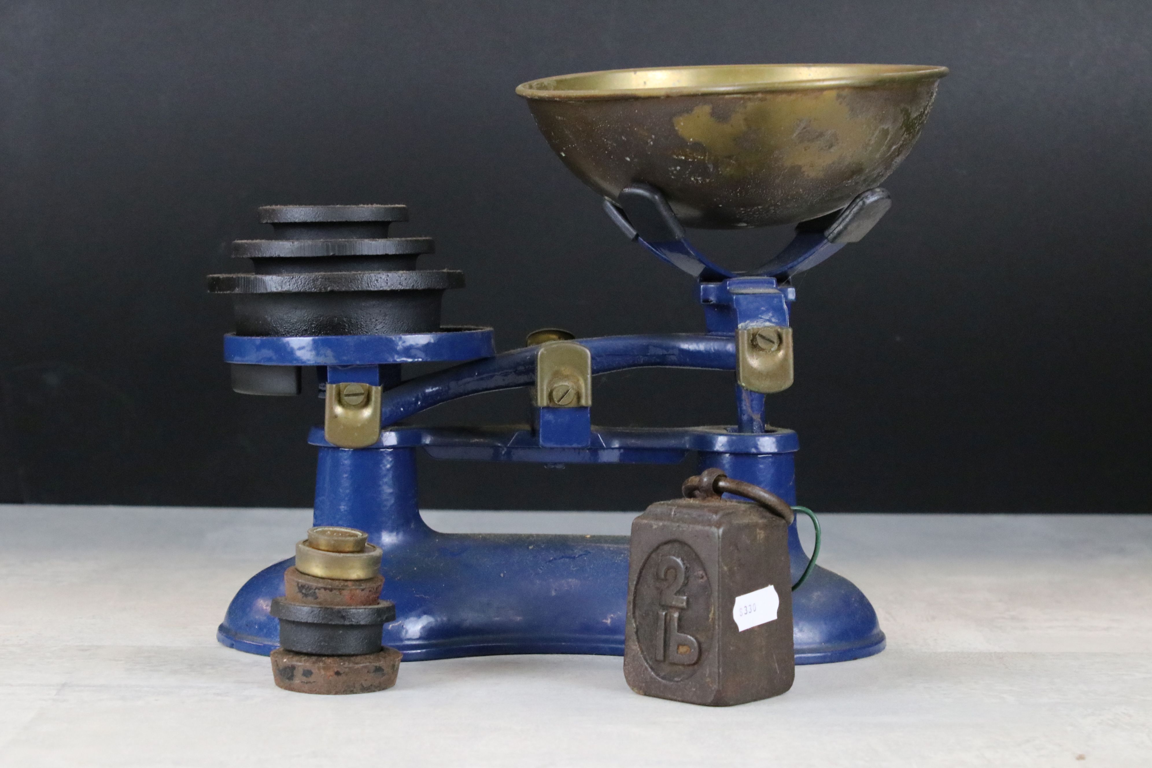 A set of blue Victor kitchen scales complete with weights.