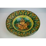Della Robbia Pottery (Birkenhead 1894-1906) Dish with incised decoration in shades of green, brown