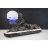 Art Deco Lamp in the form of a Spelter Lady with a Dog holding a glass speckled blue shade, raised