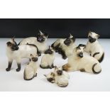 Seven Beswick Siamese Cats together with a Royal Doulton Siamese Cat