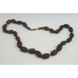 An oriental carved wooden beaded necklace.