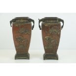 A pair of oriental bronze bud vases with Heron and floral decoration.