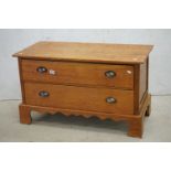 Low Golden Oak Chest of Two Long Drawers raised on bracket feet, 91cm wide x 54cm high