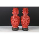 Pair of Chinese Red Cinnabar Baluster Vases decorated with a band of dragons, with blue enamel