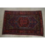 Eastern Wool Red Ground Rug with stylised pattern within a border, 197cm x 128cm