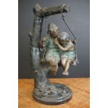 Bronze Figure Group of Boy and Girl sat on a Swing suspended from a tree, their clothing with a