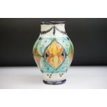 Della Robbia Pottery (Birkenhead 1894-1906) Baluster Vase with incised decoration in shades of