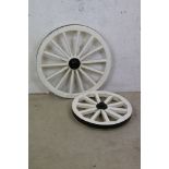 Two Wooden Cart Wheels painted black and white, largest 65cm diameter