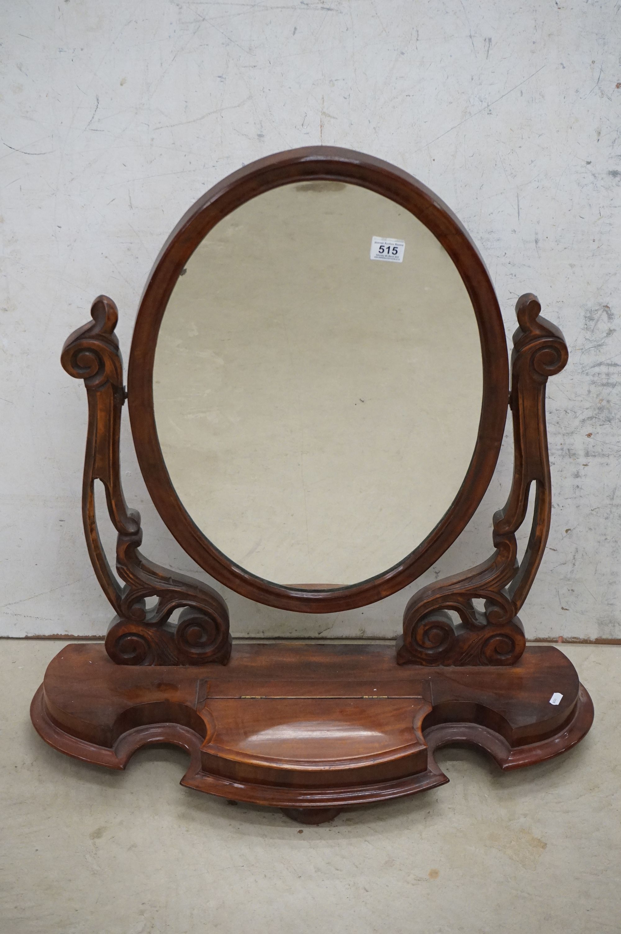 Victorian Mahogany Oval Swing Dressing Mirror, the shaped base with glove drawer raised on squat