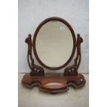 Victorian Mahogany Oval Swing Dressing Mirror, the shaped base with glove drawer raised on squat