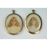 Two hand painted miniature portraits in yellow metal frames.