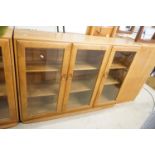 Ercol Pale Elm Bookcase / Display Cabinet with three bevelled glazed doors enclosing adjustable