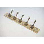 Set of Five Iron Coat Hooks mounted on a carved oak back plate, 70cm long