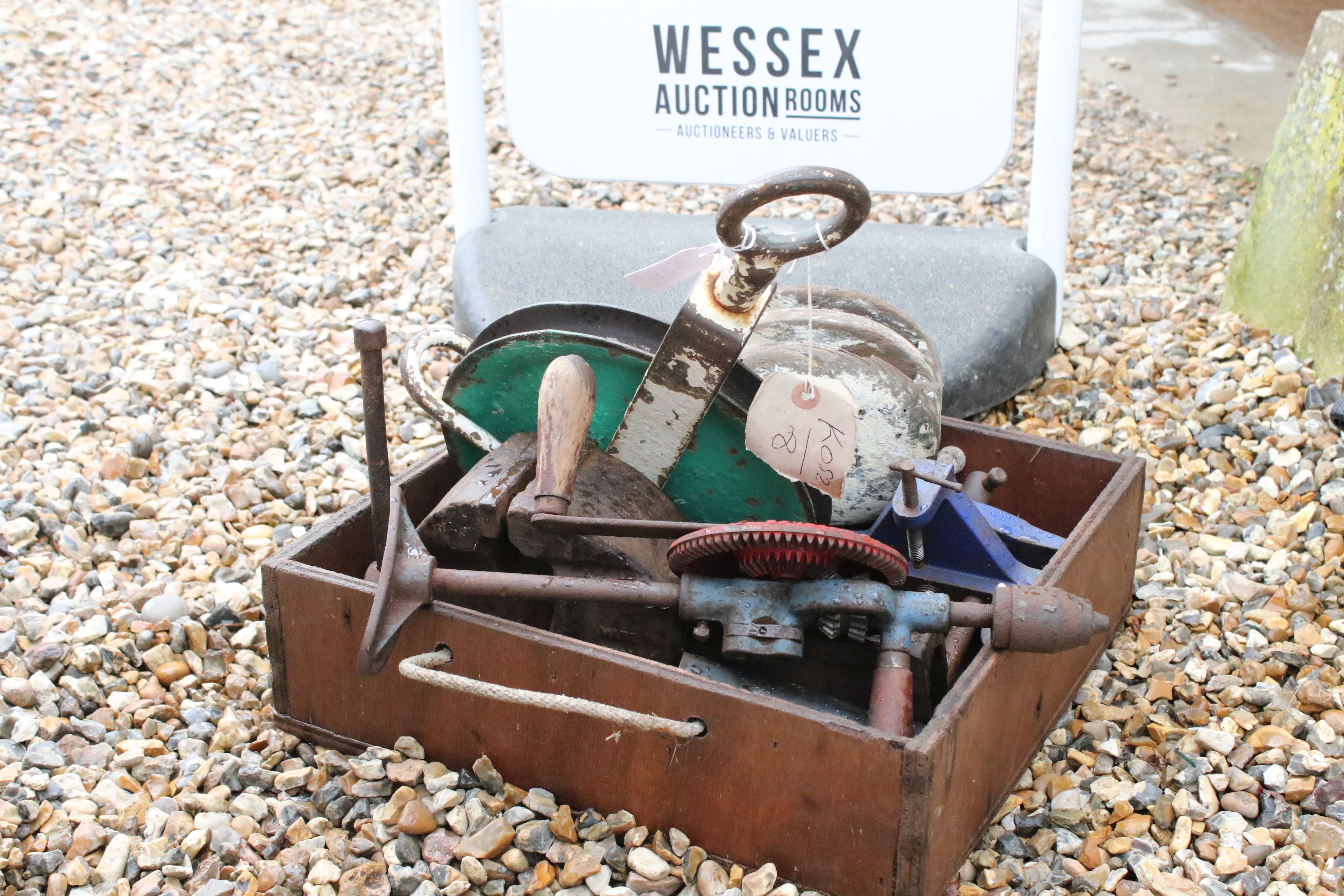 Collection of Vintage Tools to include three bench vices, iron and wood pulley, etc