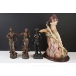 A collection of three cast metal figures of classical form together with a resin figure from Lord of