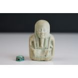 An early 20th century Egyptian carved figure together with a similar scarab beetle.