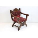 Oak X-frame Chair in the Jacobean manner with upholstered back panel and seat and carved green man