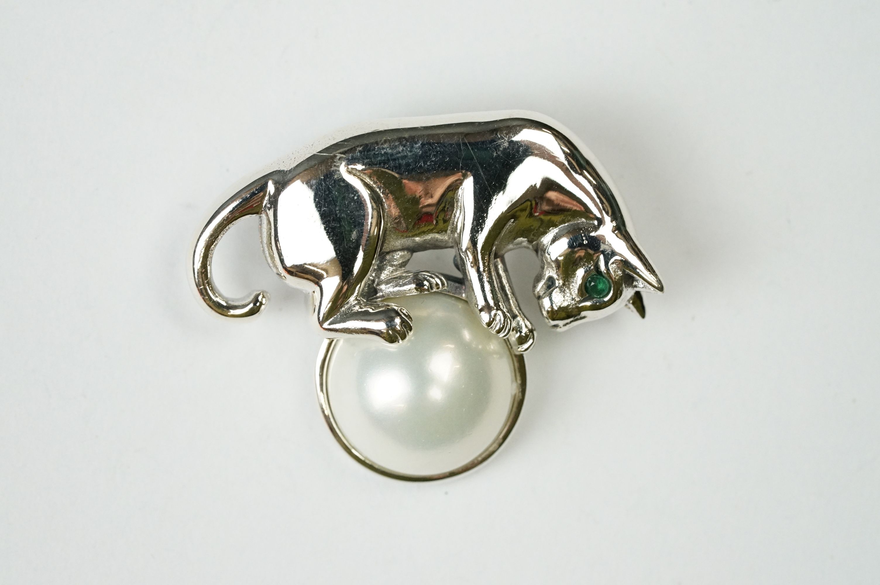 Silver Brooch in the form of a cat balancing a pearl