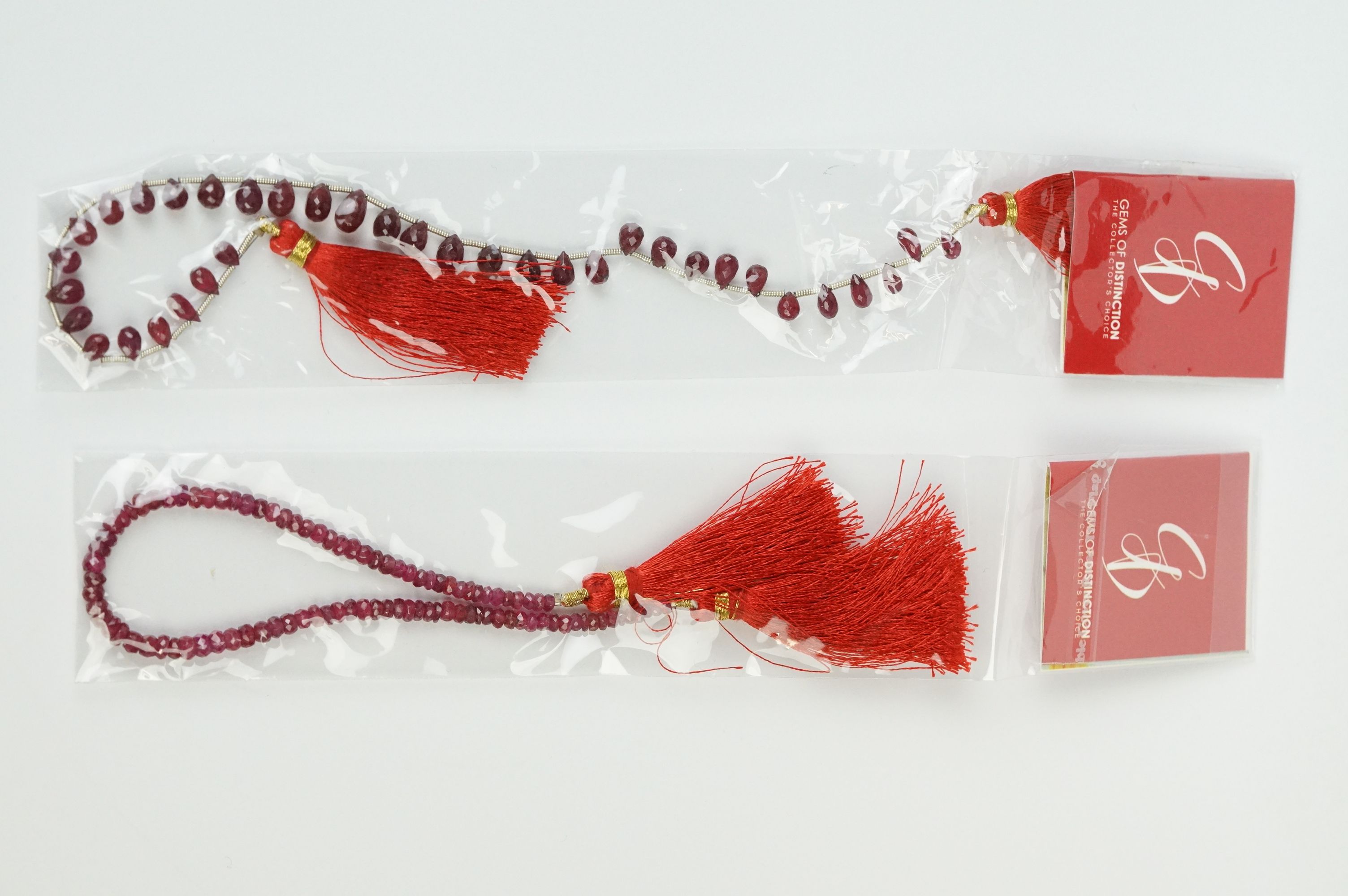 Two ruby faceted drop strands, approx 18cm in length.