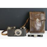 An early 20th century Leica camera with Leitz Elmar 1:3,5 F=50mm lens and brown leather case.