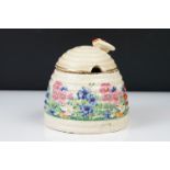 Clarice Cliff Pottery Beehive Honey Pot in the Radiance pattern (damage to wing of bee), 11cm high