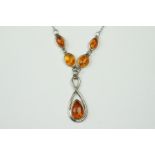 A sterling silver necklace with amber settings.