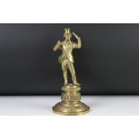 A brass figure of a gentleman in top hat, stamped with lozenge mark to verso, stands approx 24cm