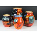 Four Poole Pottery Baluster Vases including three in the Gemstone pattern and one in the Volcano