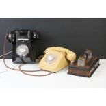 Two vintage B.T. home telephones together with a desk stand with inkwells.