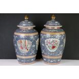 Pair of Chinese Ceramic Famille Rose Baluster Jars with Covers, the blue ground decorated with