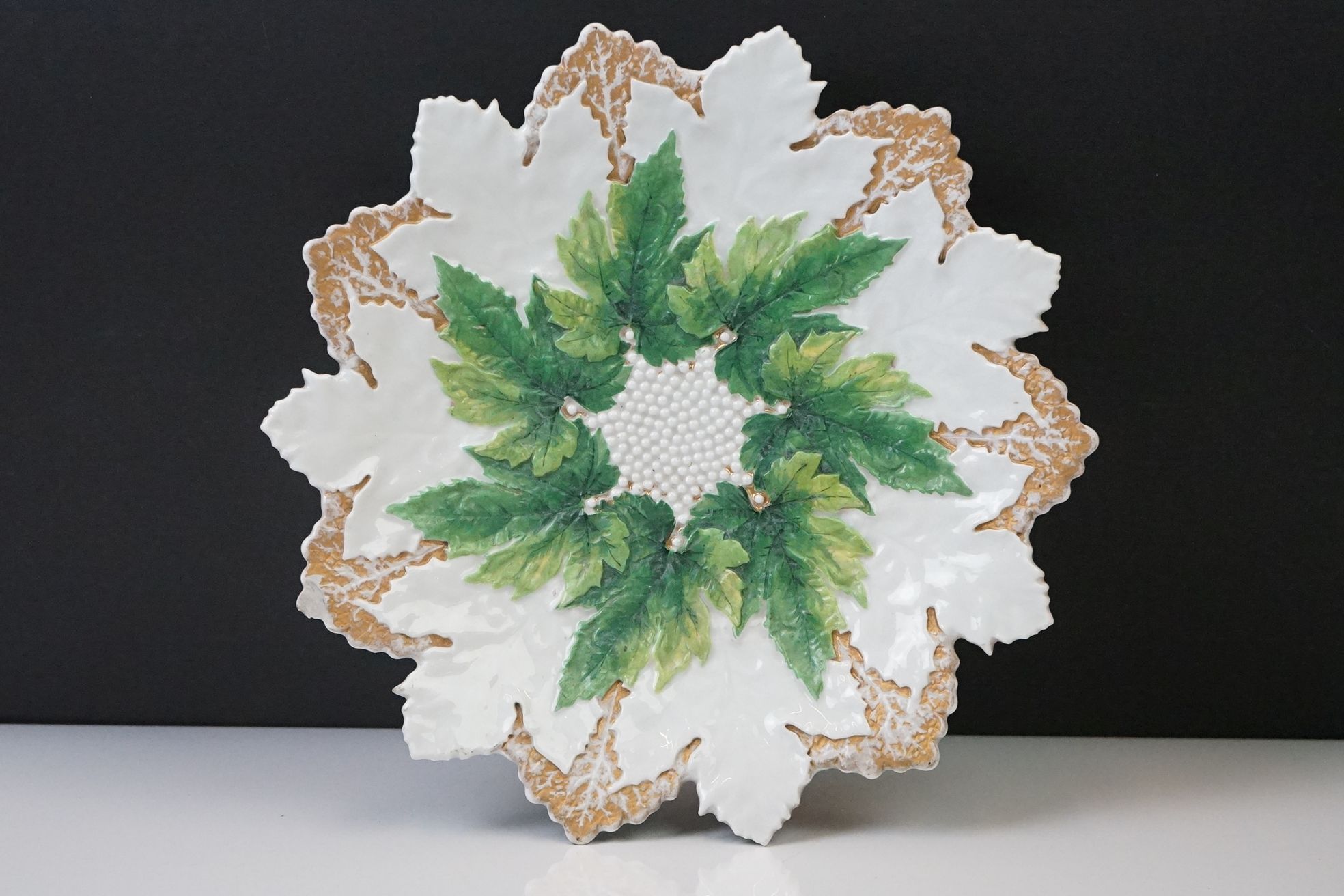 Early 20th century Meissen relief moulded vine leaf cabinet plate, in green and gilt, crossed swords