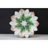 Early 20th century Meissen relief moulded vine leaf cabinet plate, in green and gilt, crossed swords