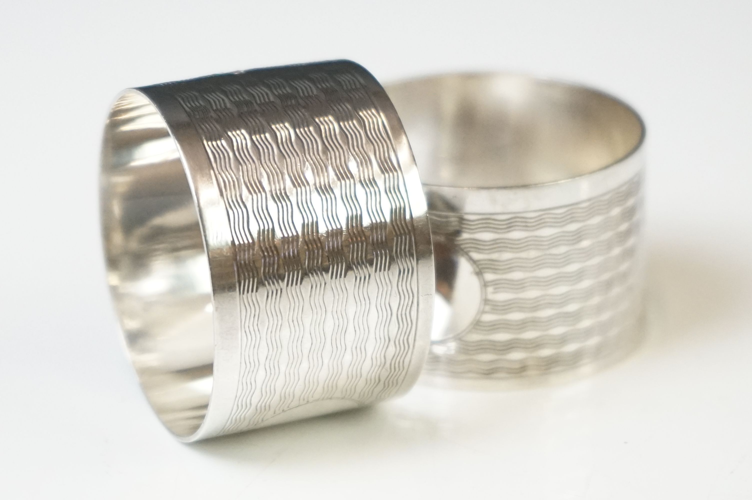 A pair of fully hallmarked sterling silver napkin rings with engine turned decoration and original - Image 3 of 7