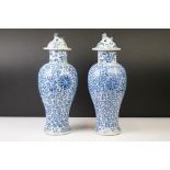 Near Pair of Chinese Blue and White vases & covers, of baluster form, with scrolling foliate &