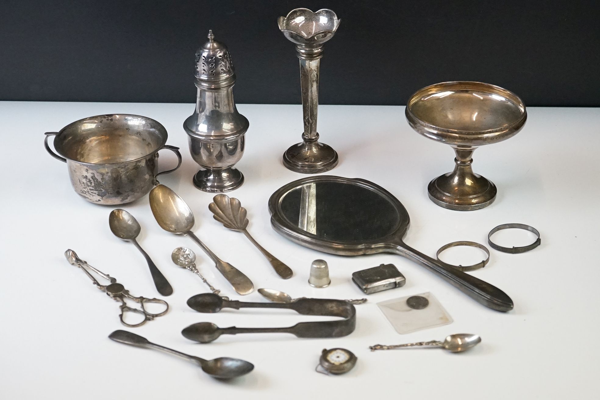 A collection of mainly fully hallmarked sterling silver to include sugar shaker, hand mirror, tazza,