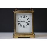 A French carriage clock with bevelled glass panels and white enamel dial, complete with key.